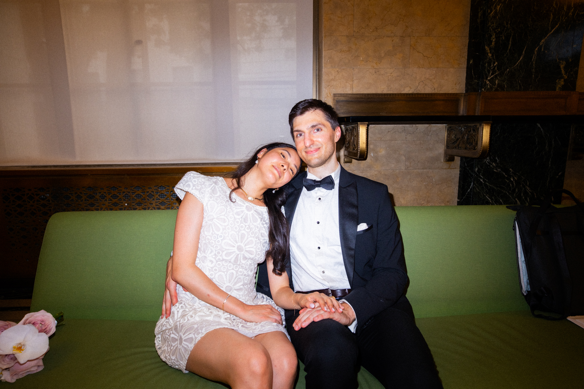 Joyce and Alex relaxing together on a green courthouse sofa