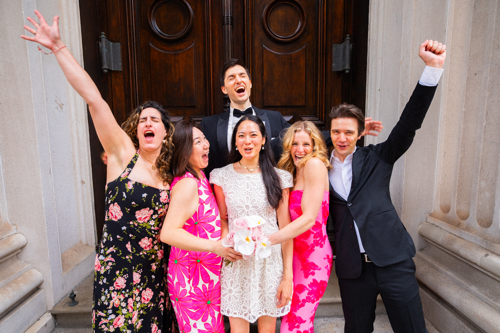 Joyce and Alex celebrating with their friends outside the courthouse